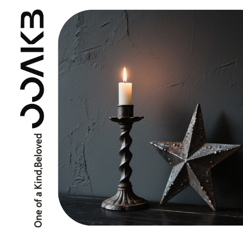 A vintage candlestick glows warm, paired with a weathered star. Light & shadow blend "One of a Kind, Beloved" romance for wedding rituals.
