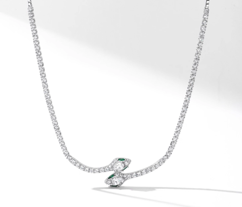 April Birthstone Diamond Necklace – Silver-toned tennis chain with a snake-shaped pendant, featuring pear-cut genuine diamonds and accent emeralds. A timeless luxurious piece for April gifting or everyday elegance.