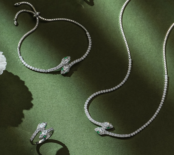 April Birthstone Diamond Jewelry Set – Includes necklace, ring, and bracelet, all featuring snake motifs with pear-cut genuine diamonds and accent emeralds in a cohesive silver-toned design. A complete luxurious set for April milestones.