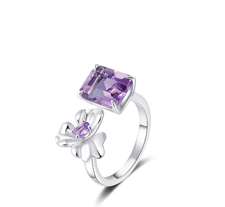 Silver-toned ring with a large square-cut purple amethyst and a flower-shaped side detail (set with a small purple stone). Elegant, nature-inspired design, suitable for gifting or daily wear.