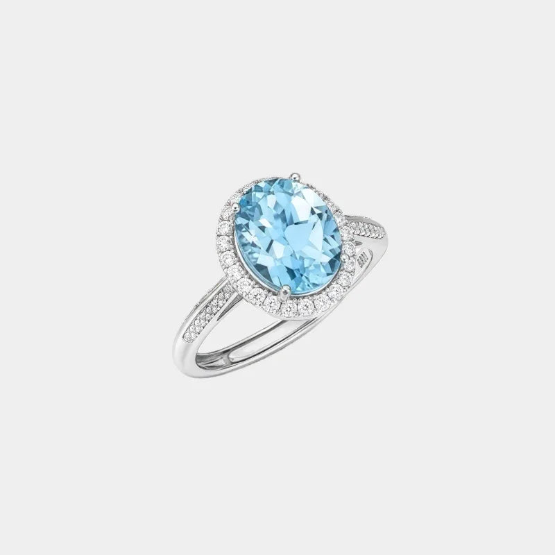 Oval Sky Blue Topaz Halo Ring — isolated front view of the ring