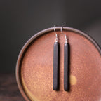 Handmade Ebony Wood Long Drop Earrings, product view on a neutral background