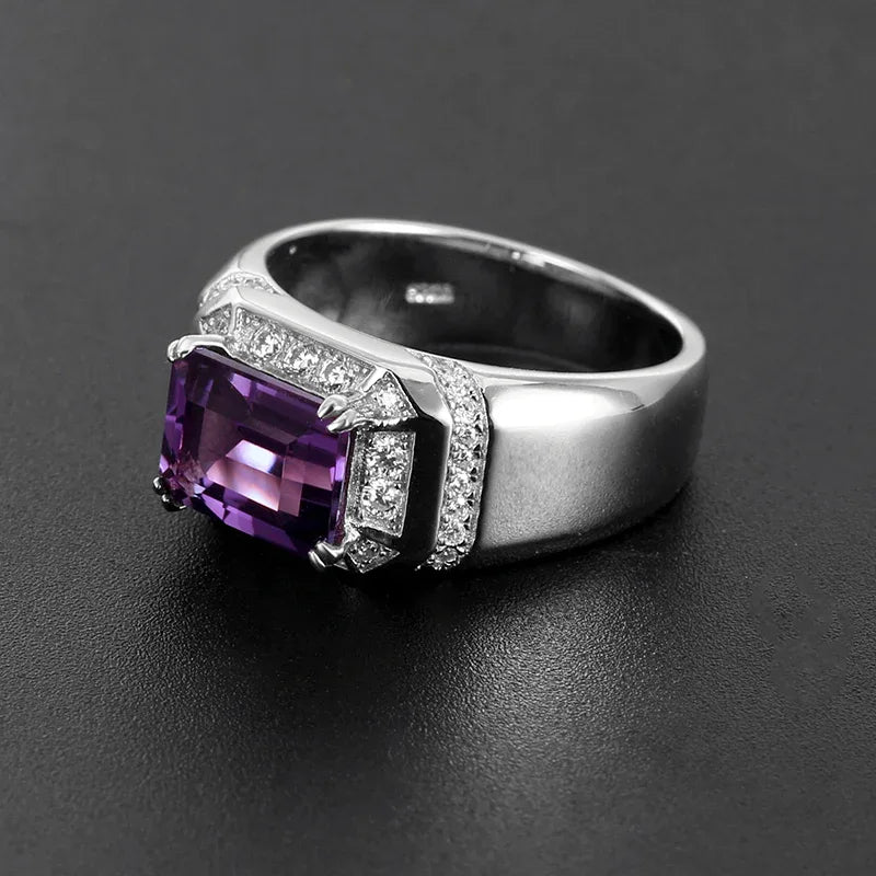 men's emerald-cut amethyst halo ring front setting detail on a dark background