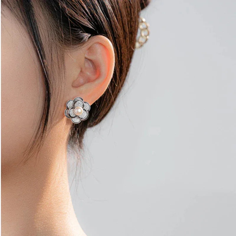 Freshwater Pearl Camellia Stud Earrings — left-ear worn close-up showing scale