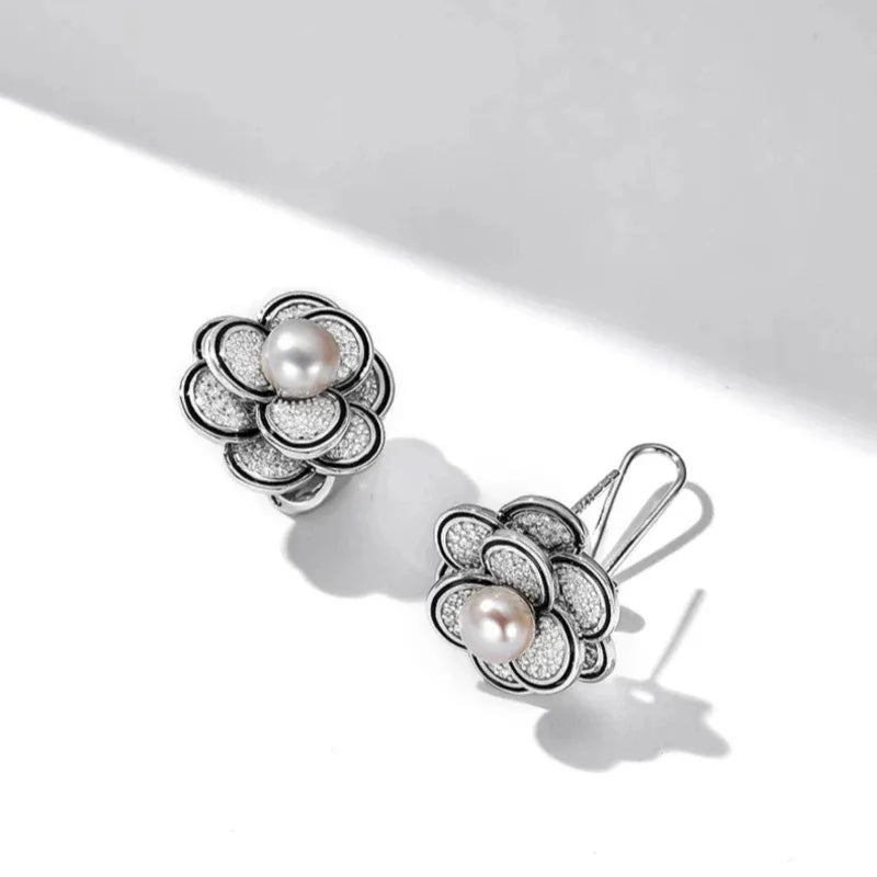Freshwater Pearl Camellia Stud Earrings — angled pair on white showing the post backs