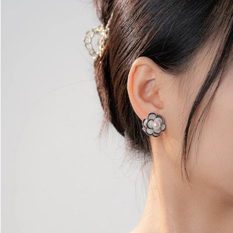 Freshwater Pearl Camellia Stud Earrings — right-ear worn close-up showing the flower profile