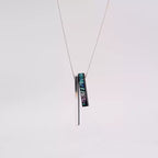 This pendant necklace features a sleek S999 silver bar and a vibrant mother - of - pearl inlaid sandalwood piece. The 70cm S925 silver chain complements the 5cm pendant. Ideal as a unique wooden wedding gift, it combines elegance and personalization.