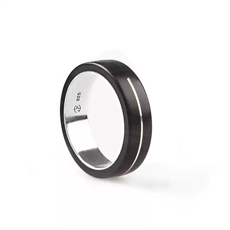 A black-purple sandalwood inlaid 925 silver couple ring with an inner silver band. The ring is a customized wooden wedding gift option, allowing for engraving. It combines natural wood with silver, making it a unique and meaningful choice.