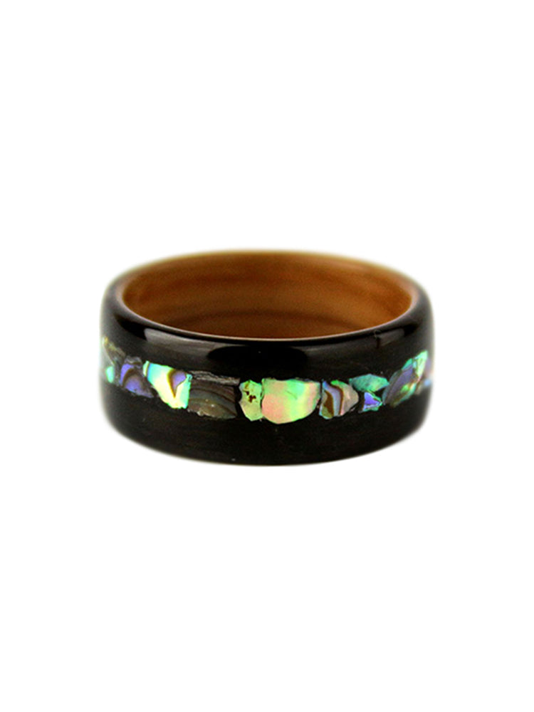 A wooden ring with a glossy finish, featuring a unique inlay of shell mother-of-pearl pieces. This customized ring is perfect as a wooden wedding gift, offering a one-of-a-kind piece for your special occasion.