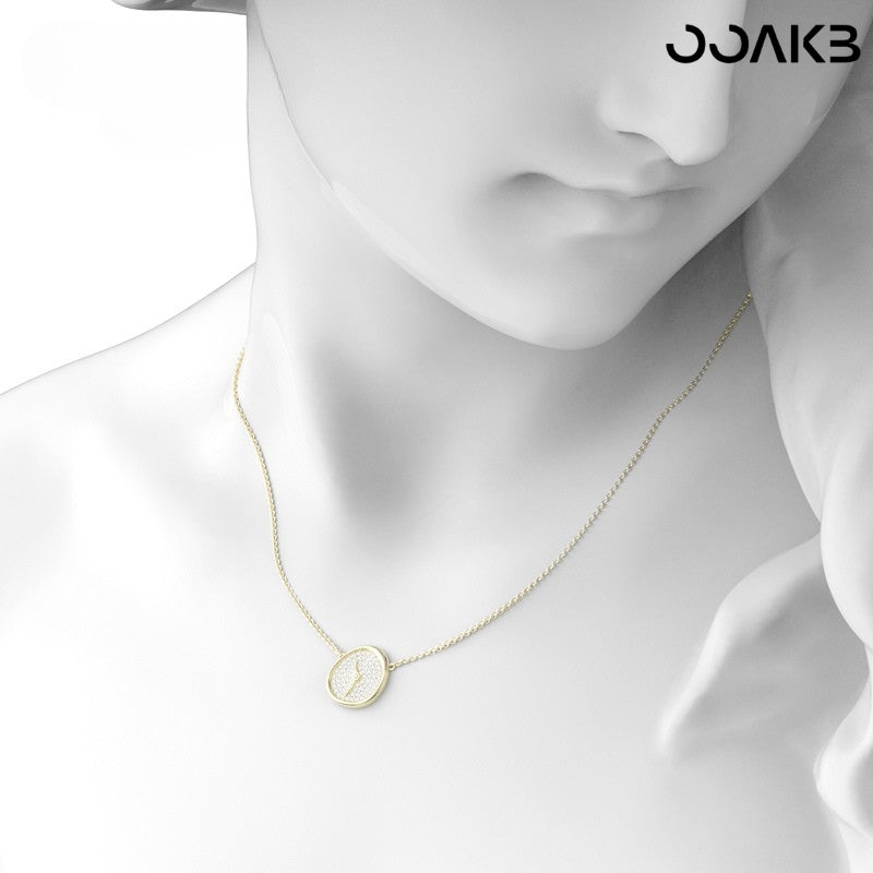 Close-up of the gold clock necklace on a mannequin, emphasizing its polished finish and paper wedding symbolism.