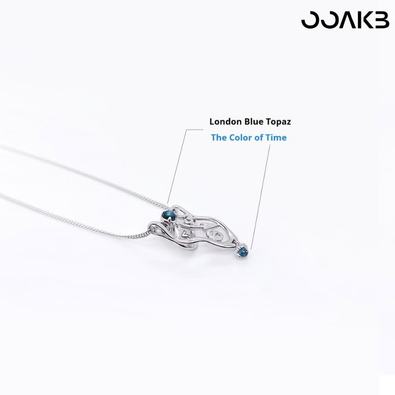 Dali-inspired silver clock necklace with London Blue Topaz, embodying "time’s color" for 1st anniversary.