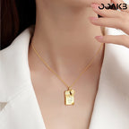 Woman wearing gold love note necklace, showcasing its chic appeal for 1st anniversary.