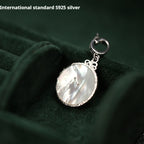 Mother-of-pearl face of 925 silver clock pendant, symbolizing timeless love for paper wedding.