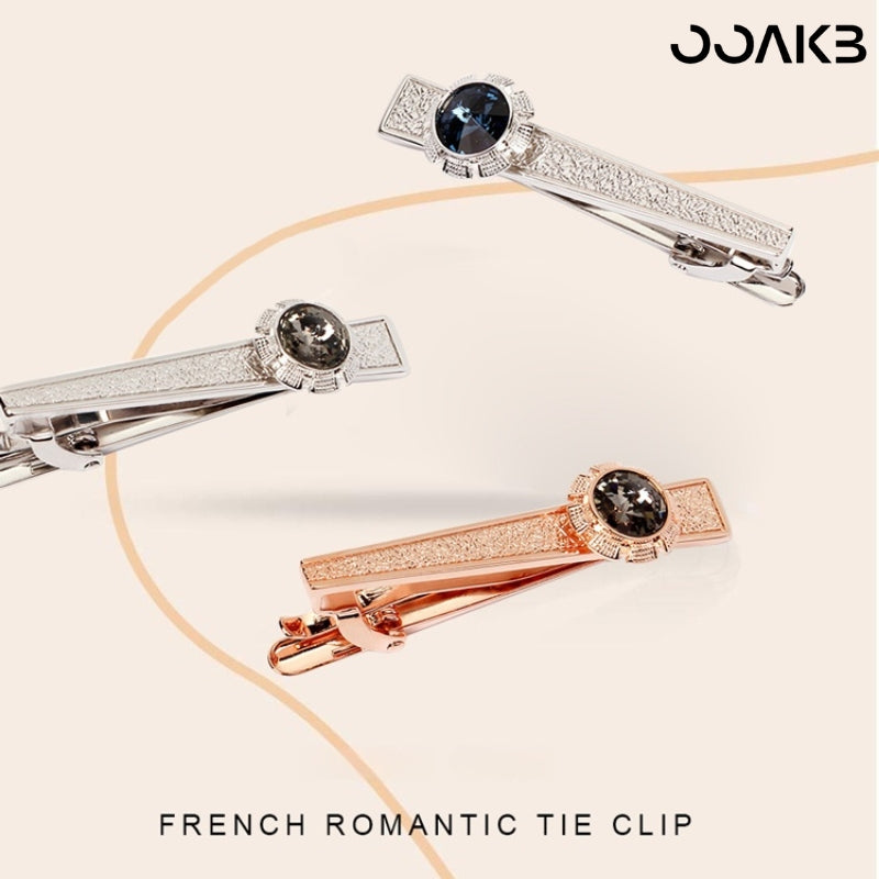 Tie clip displayed with "French Romantic" theme text emphasizing elegance.