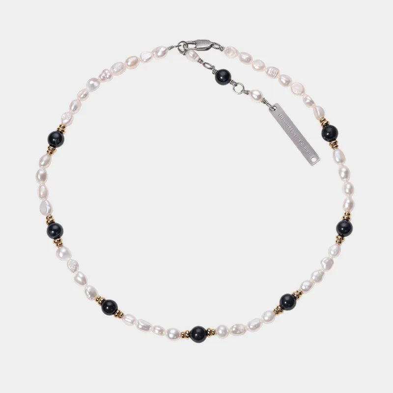 Baroque Pearl and Tiger Eye Beaded Necklace — front view of pale baroque pearl strand with spaced dark round beads