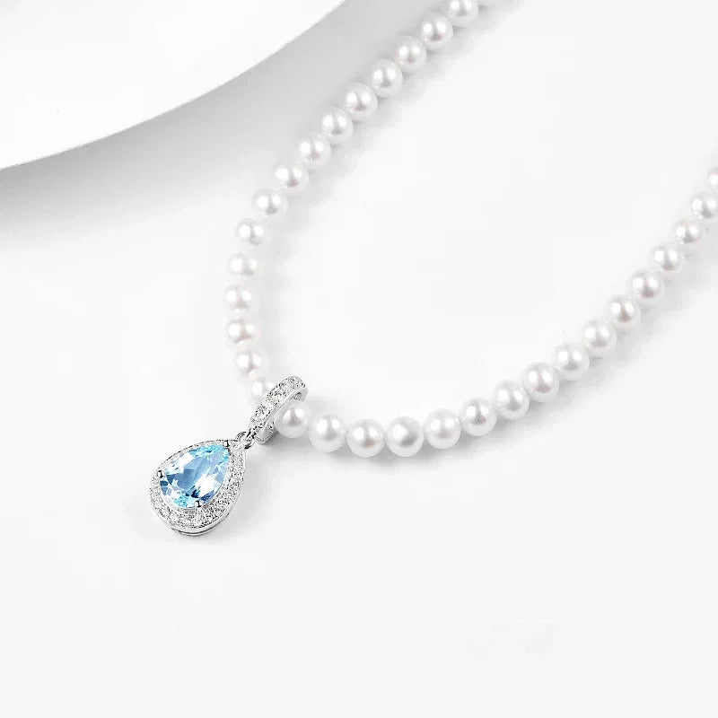 Aquamarine Teardrop Pendant Pearl Necklace — angled necklace close-up on white