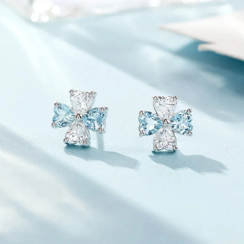 Aquamarine Bow Stud Earrings worn on the ear from a second angle