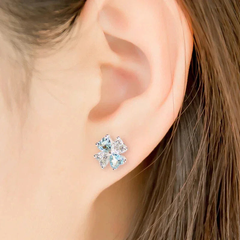 Aquamarine Bow Stud Earrings worn on the ear in a close-up