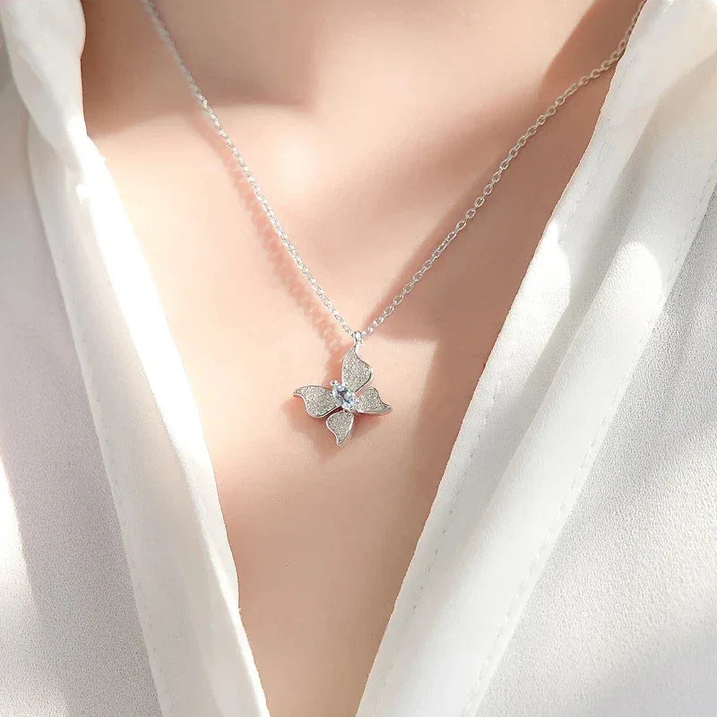 Aquamarine Butterfly Pendant Necklace worn at the neckline from a second angle