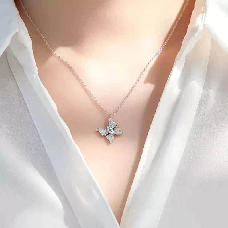 Aquamarine Butterfly Pendant Necklace worn at the neckline in a close-up