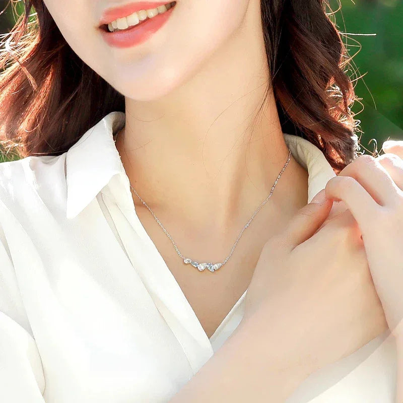 Aquamarine Five-Stone Curved Necklace worn at the neckline in a close-up