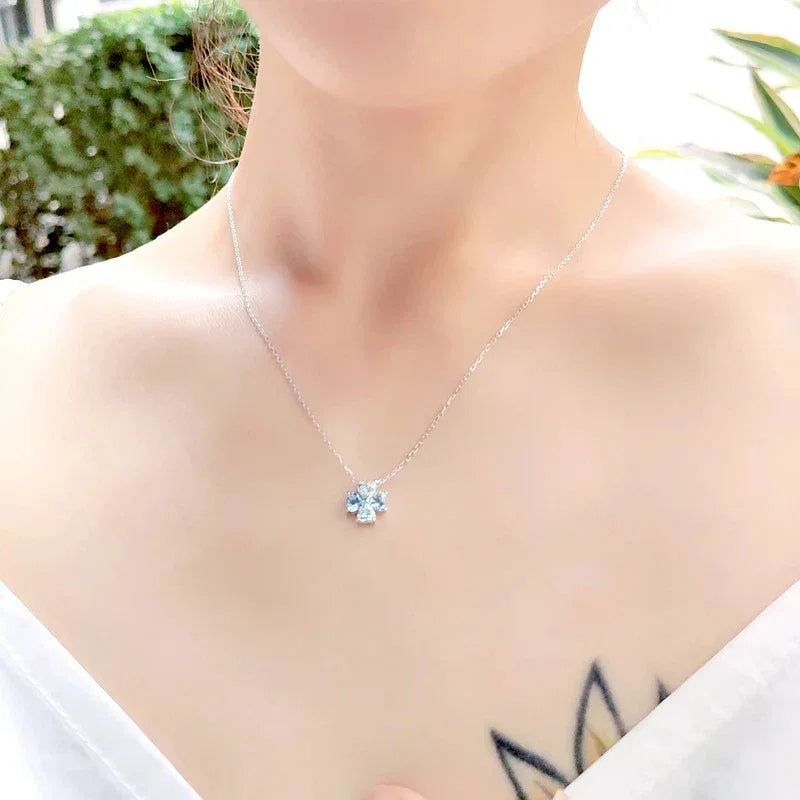Aquamarine Four-Stone Cluster Pendant Necklace worn at the neckline in a close-up