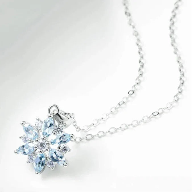 Aquamarine Snowflake Pendant Necklace pendant and chain detail on a light background