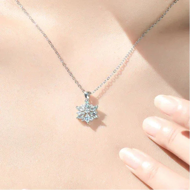 Aquamarine Snowflake Pendant Necklace worn at the neckline in a close-up