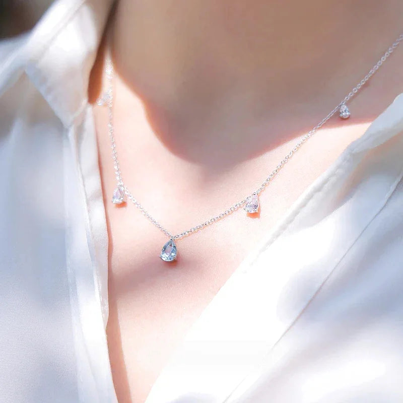 Aquamarine Station Drop Necklace worn at the neckline in a close-up