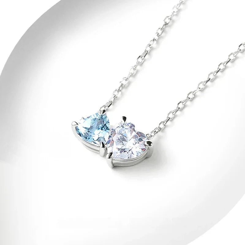 Aquamarine Two-Heart Pendant Necklace angled pendant detail on white