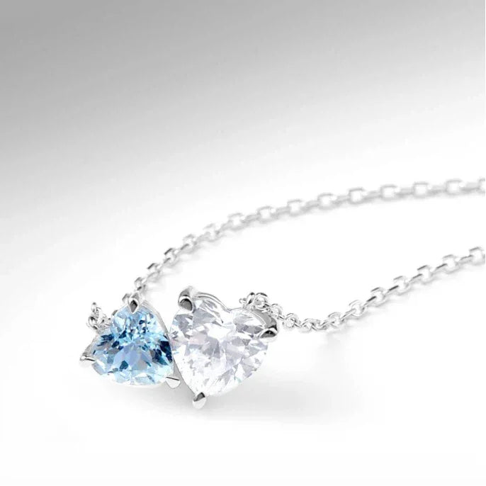 Aquamarine Two-Heart Pendant Necklace pendant and chain detail on a light background