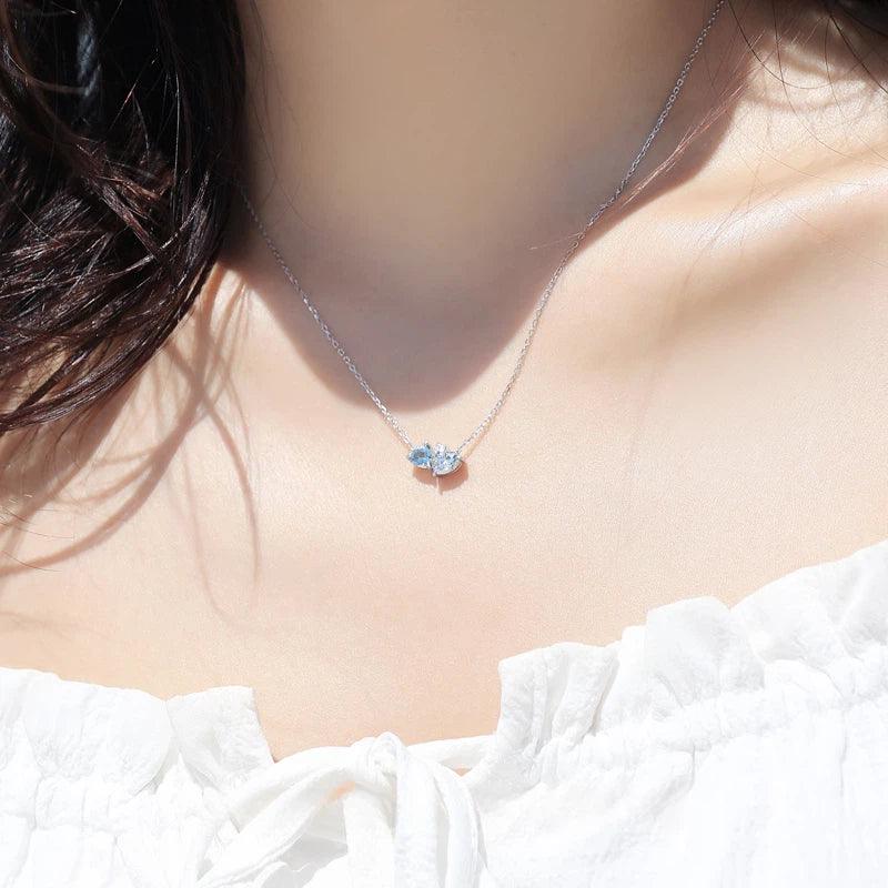 Aquamarine Two-Heart Pendant Necklace styled neckline view showing pendant scale