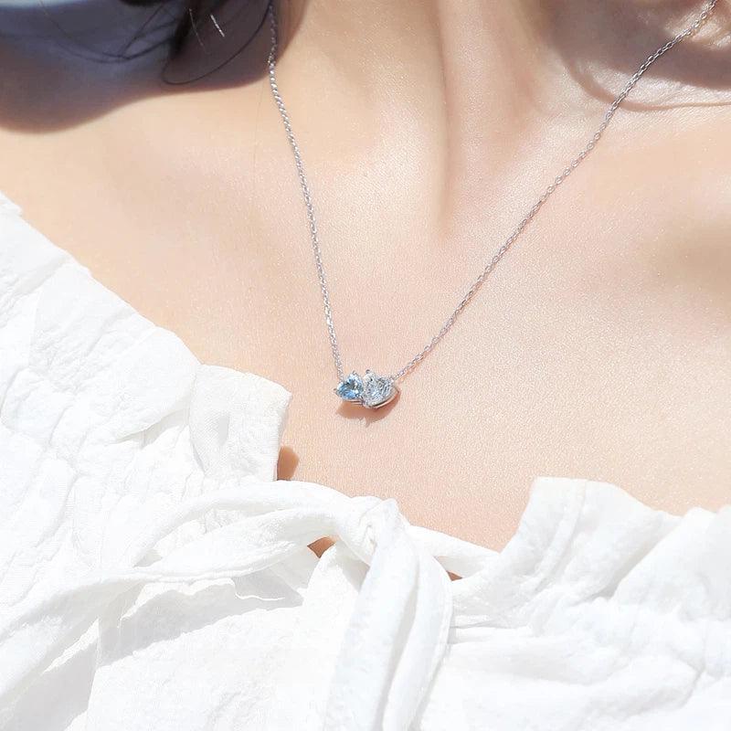 Aquamarine Two-Heart Pendant Necklace worn at the neckline from a second angle