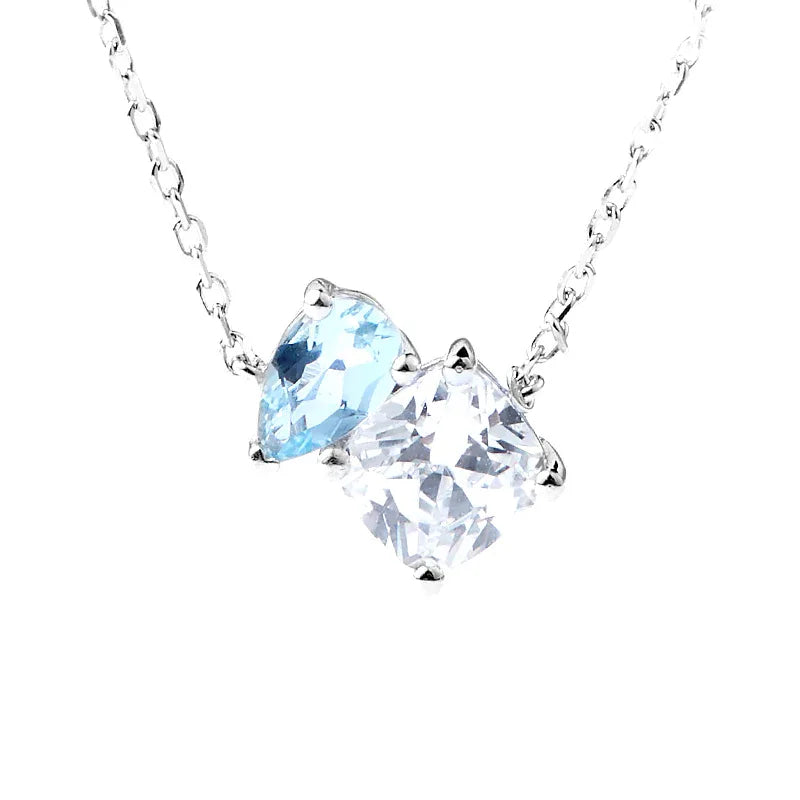 Aquamarine Two-Stone Pendant Necklace pendant and chain detail on a light background