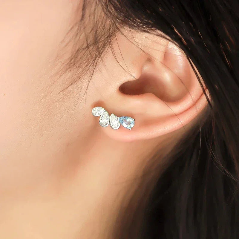 Asymmetric Aquamarine Leaf Drop Earrings worn on the ear in a close-up
