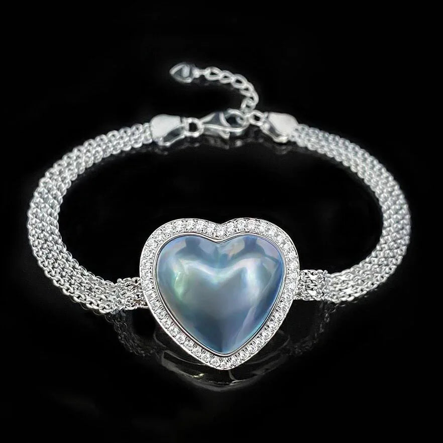 Blue Iridescent Pearl Heart Halo Bracelet — bracelet displayed on a black background