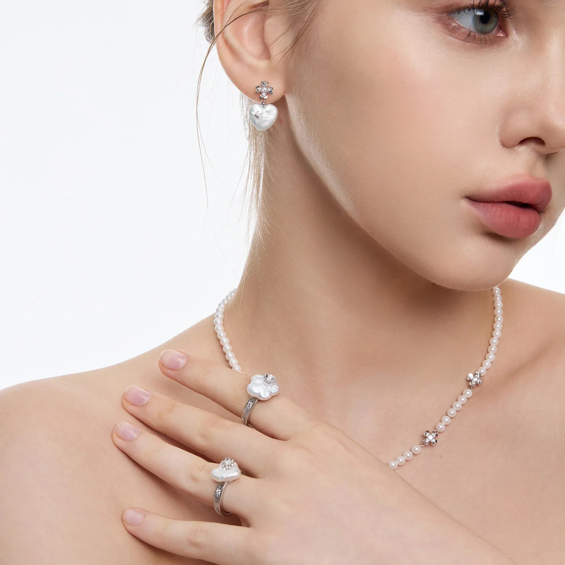 Pearl Heart Drop Earrings with Floral Tops — front model portrait wearing the earrings with matching necklace