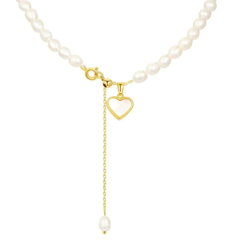 Pearl Toggle Lariat Necklace with Open Heart — macro view of the toggle, open heart and pearl-tipped hanging chain