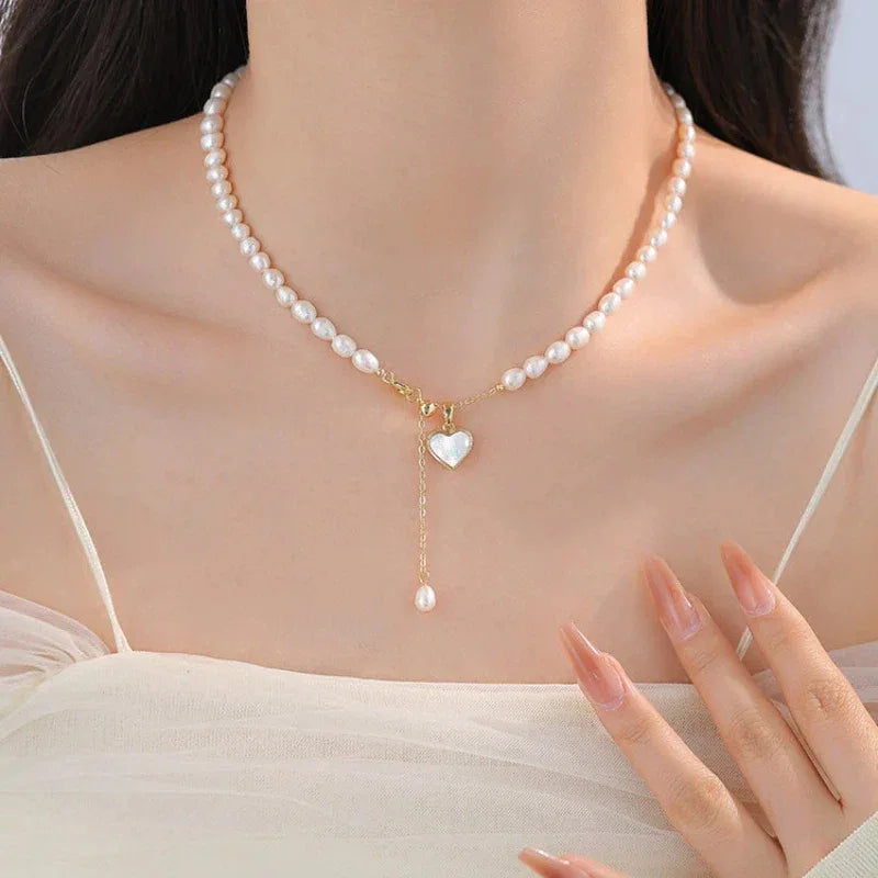 Pearl Toggle Lariat Necklace with Open Heart — close neckline-worn view showing the lariat drop