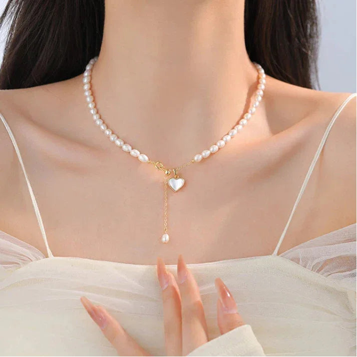 Pearl Toggle Lariat Necklace with Open Heart — front neckline-worn portrait over a white dress