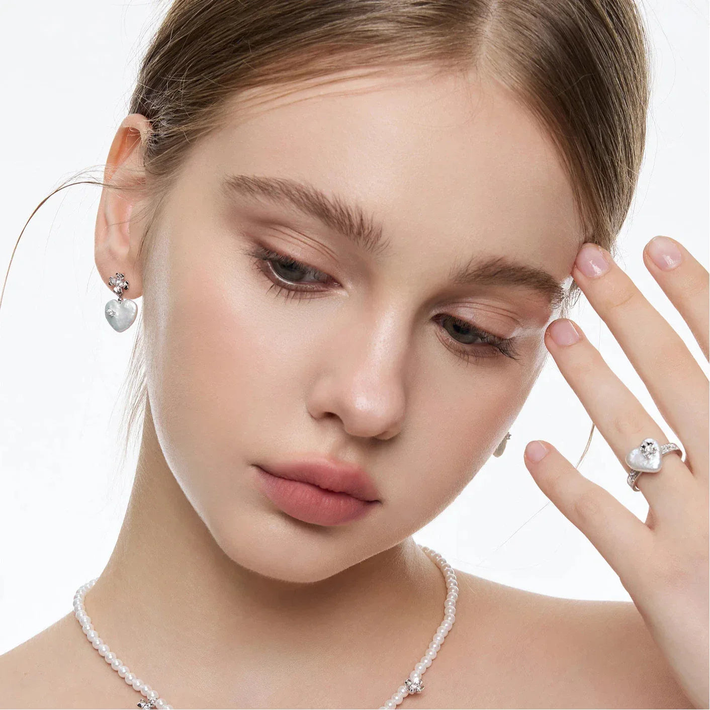 Baroque Pearl Heart Open Ring with Floral Detail — model looking down at the ring