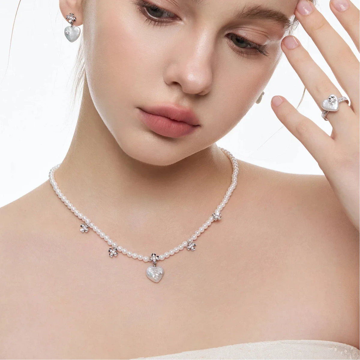 Pearl Heart Necklace with Floral Stations — closer neckline-worn view with the pearl strand and flower stations