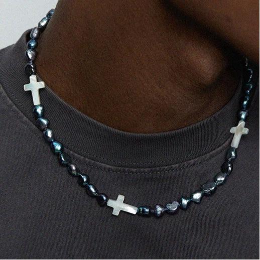Dark Baroque Pearl Necklace with White Cross Accents — front neckline-worn view over a dark shirt