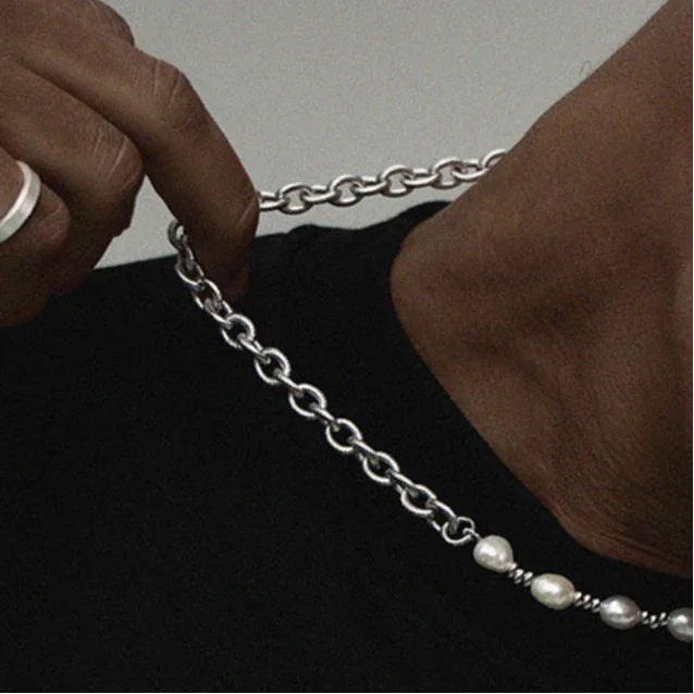Baroque Pearl and Spiral Chain Half-and-Half Necklace — close worn view with a hand lifting the spiral chain