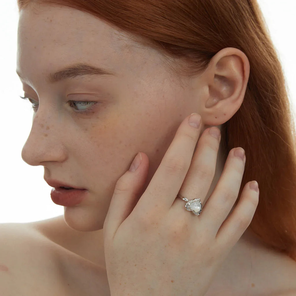 Open Pearl Heart Ring — model portrait with the ring beside the face