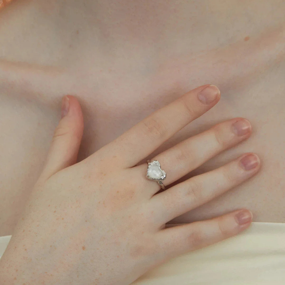 Open Pearl Heart Ring — alternate hand-worn view showing the open band