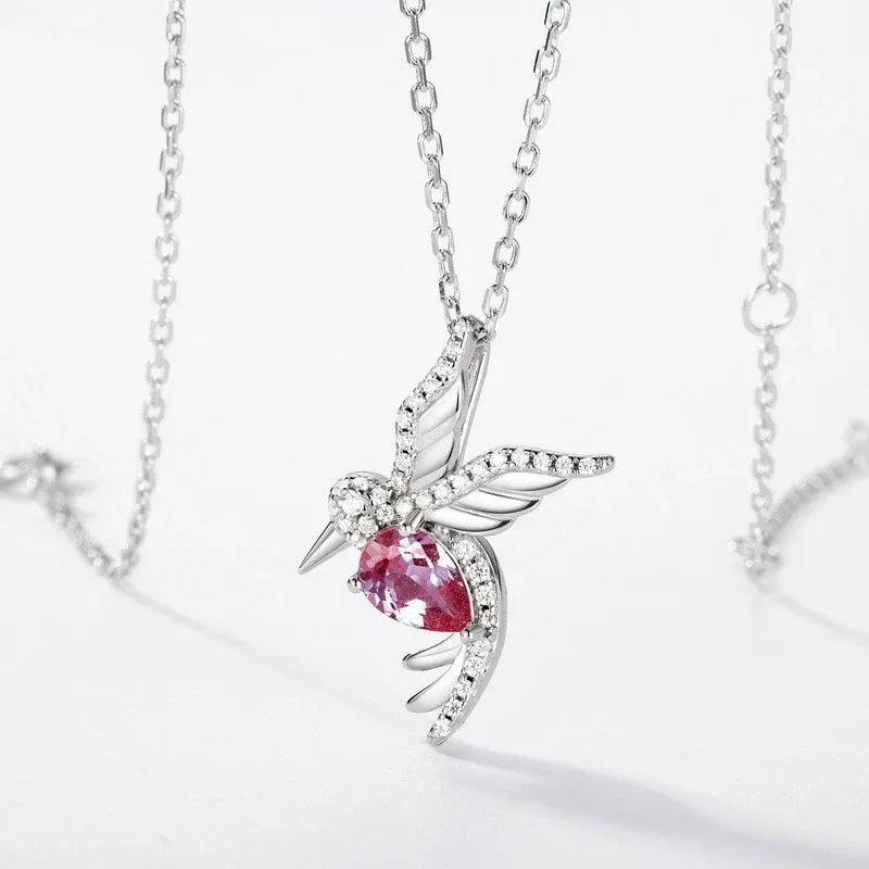 Bird-shaped pendant necklace with a Alexandrite body, pink-toned Alexandrite view under alternate lighting