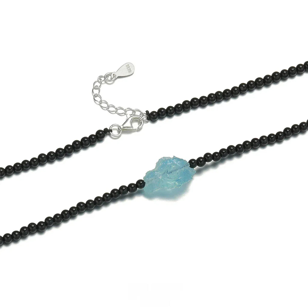 Black Agate and Raw Aquamarine Beaded Necklace pendant and chain detail on a light background
