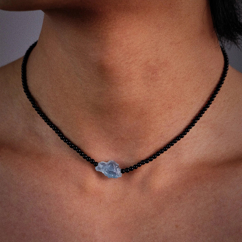 Black Agate and Raw Aquamarine Beaded Necklace worn at the neckline in a close-up