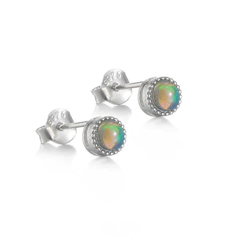 Black Opal Round Stud Earrings worn on the hand from another angle